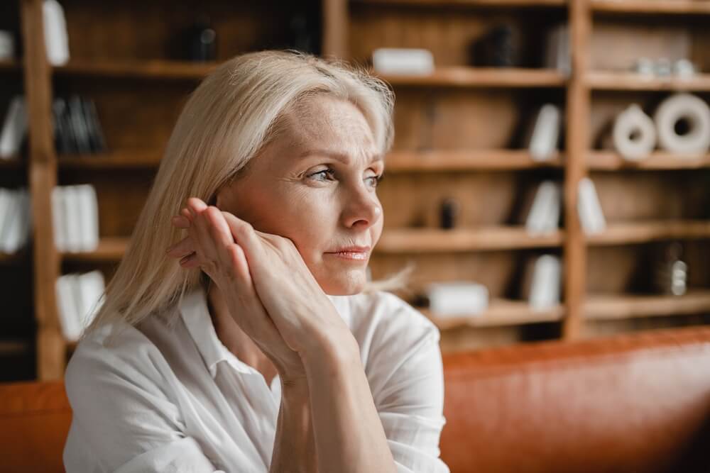 Stressed Sad Tired Exhausted Caucasian Middle-Aged Mature Businesswoman Freelancer Relaxing on the Couch Sofa