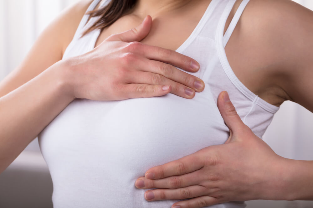 Close-up Of A Womans Hand On Breast Suffering From Pain