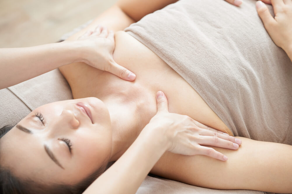 Woman Receiving Decollete Massage in Bright Beauty Salon