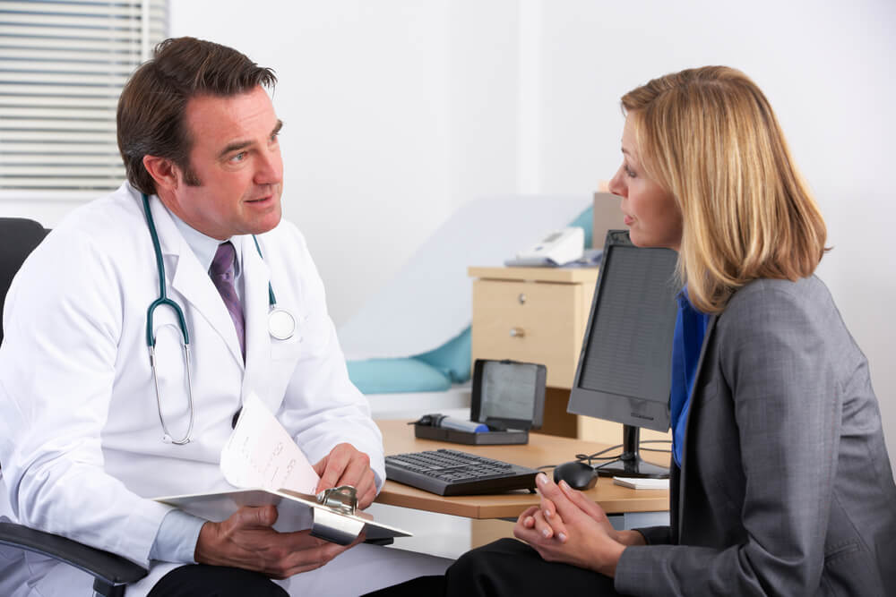 American Doctor Talking to Businesswoman Patient