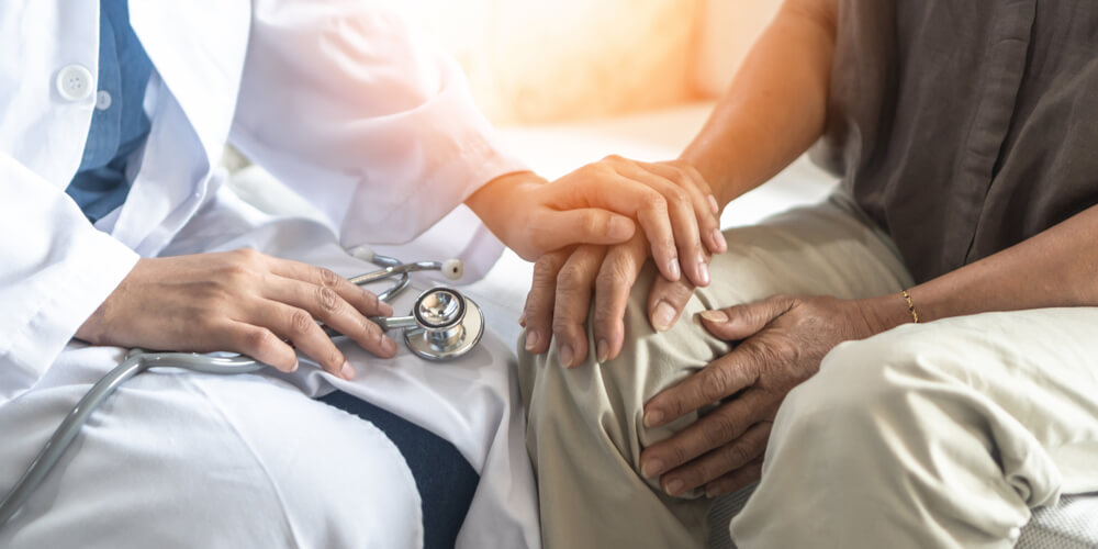 Doctor Consulting Examining Elderly Senior Aged Adult in Medical Exam Clinic or Hospital