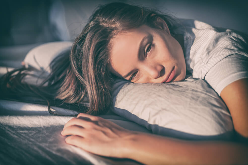 Tired Woman Lying in Bed Can’t Sleep Late at Night With Insomnia
