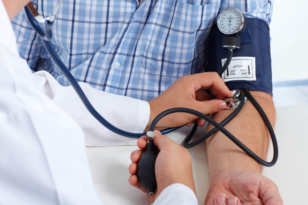 Doctor Checking Old Man Patient Arterial Blood Pressure.