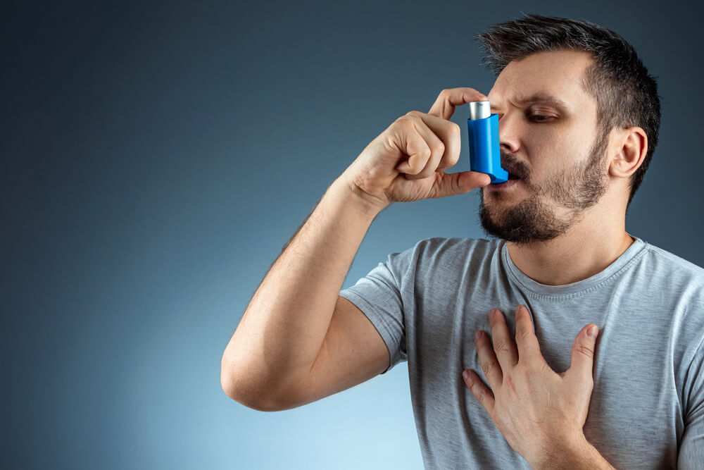 Portrait of a Man With an Asthma Inhaler in His Hands, an Asthmatic Attack