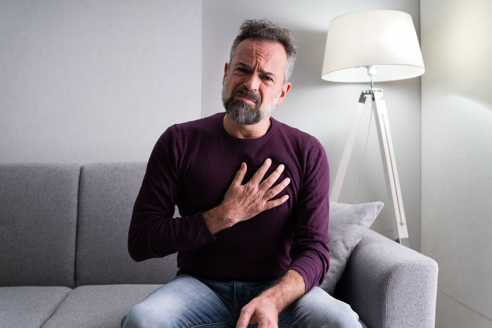 Man With Chest Pain Sitting on a Couch