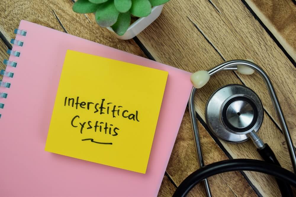 Concept of Interstitical Cystitis Write on Sticky Notes With Stethoscope Isolated on Wooden Table