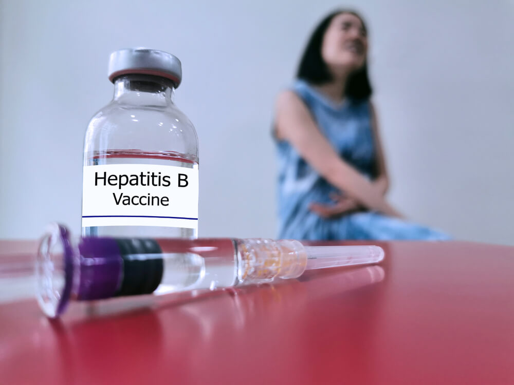Bottle Of Hepatitis B Vaccine Selective Focus For Injection And Blurred Background Of Woman
