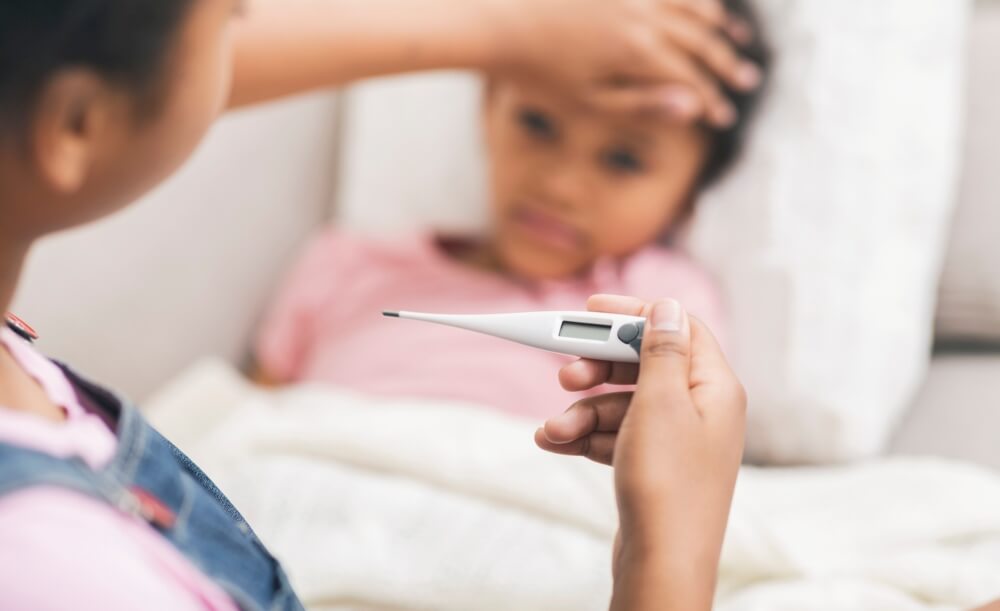 Mother Touching Her Son’s Forehead, Checking Temperature