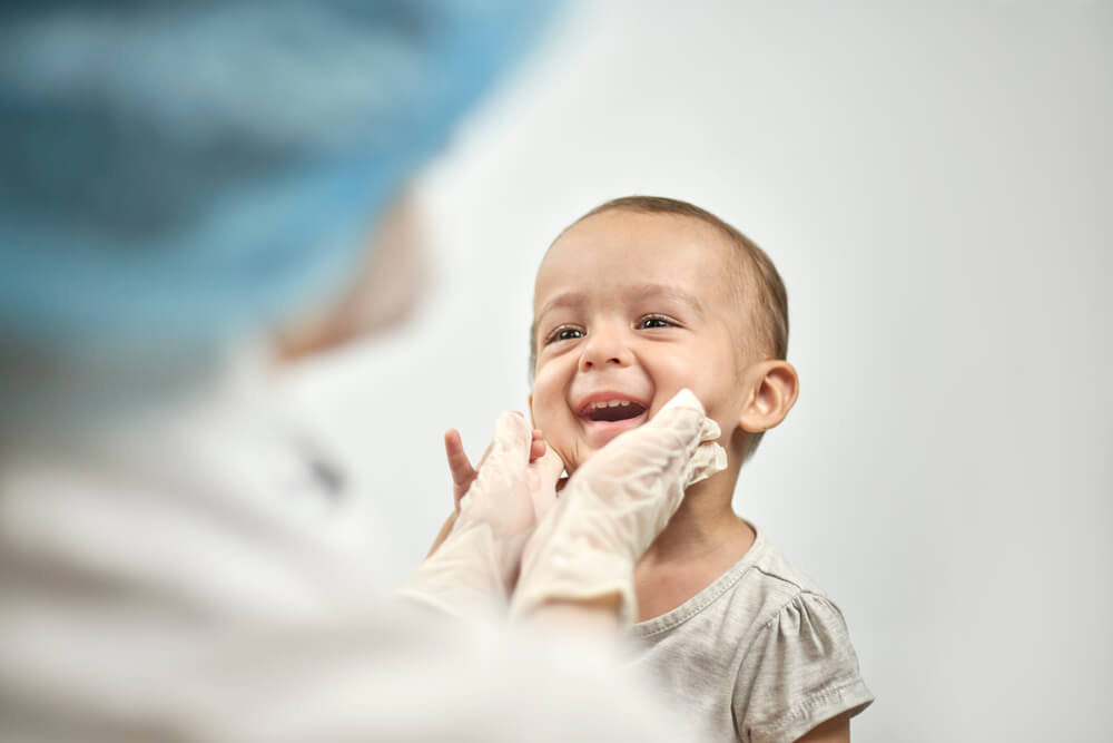 Pediatrician Checking Baby Teeth. Dentist Examines Teeth of Baby Boy