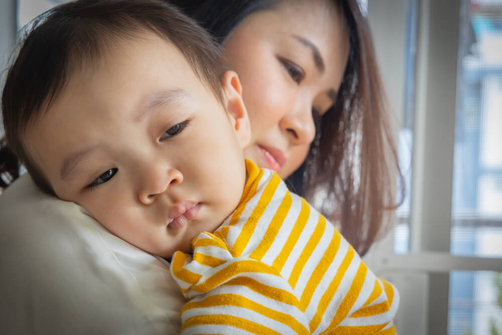 An Asian Boy Was Crying in Sorrow, Being Carry by His Mother to Calm Down.