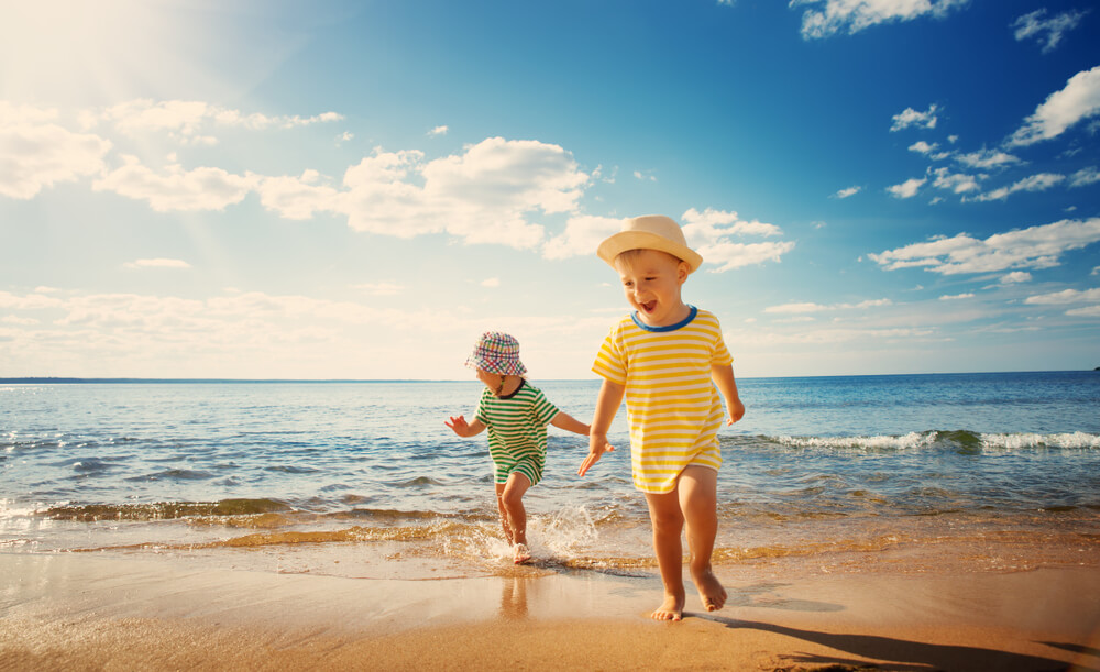 Boy and Girl Playing on the Beach on Summer Holidays.