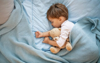 Photo of Baby Boy Sleeping Together With Teddy Bear