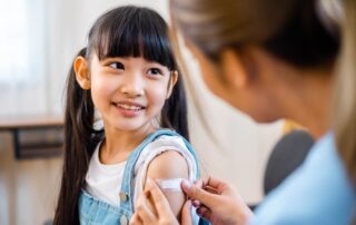 Childhood Vaccination Asian Young Woman Doctor Vaccinating Little Girl At Home