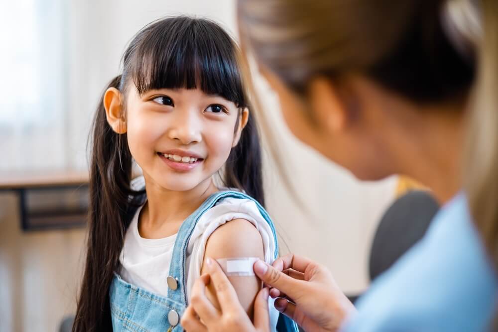 Childhood Vaccination Asian Young Woman Doctor Vaccinating Little Girl At Home