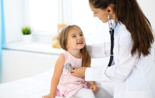 Doctor Examining A Little Girl By Stethoscope