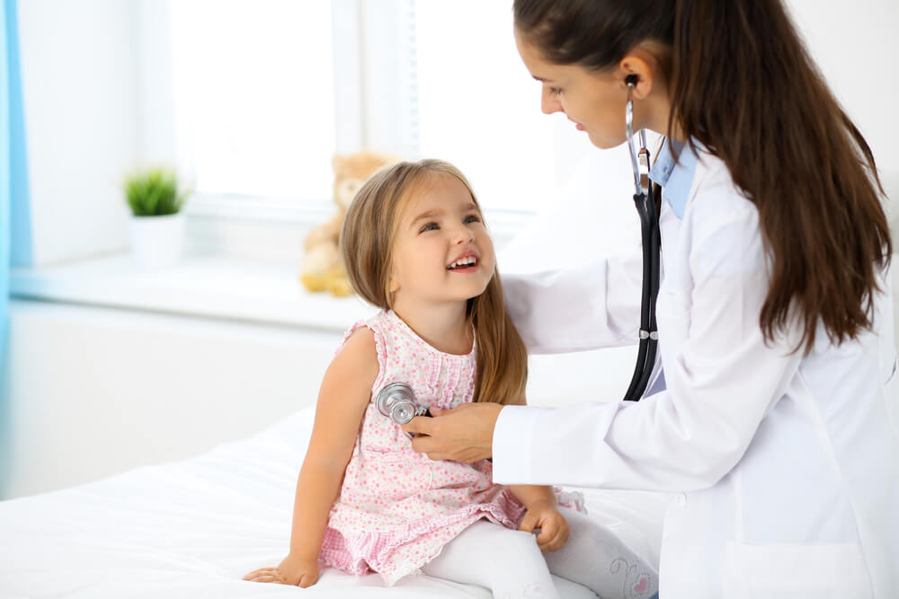 Doctor Examining A Little Girl By Stethoscope