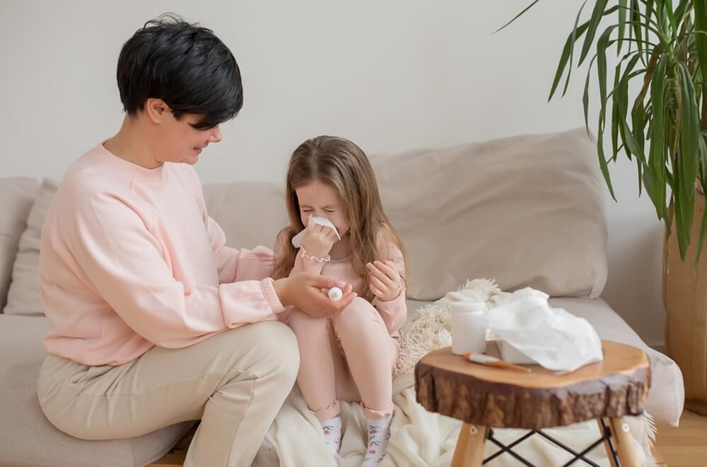 Mom Helps Her Daughter Blow Her Nose A Sick Girl Having a Runny Nose Using a Handkerchief