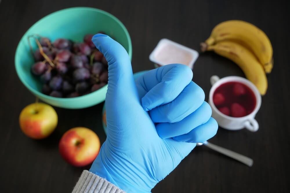 Hand In Medical Gloves Make Like On Testy Fresh Fruits And Healthy Meals Background Healthy Breakfast Anti Cholesterol Diet Closeup