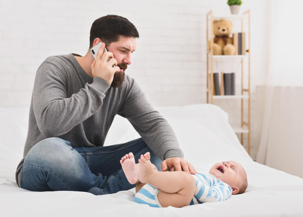 Worried Dad Massaging His Belly And Calling To Doctor
