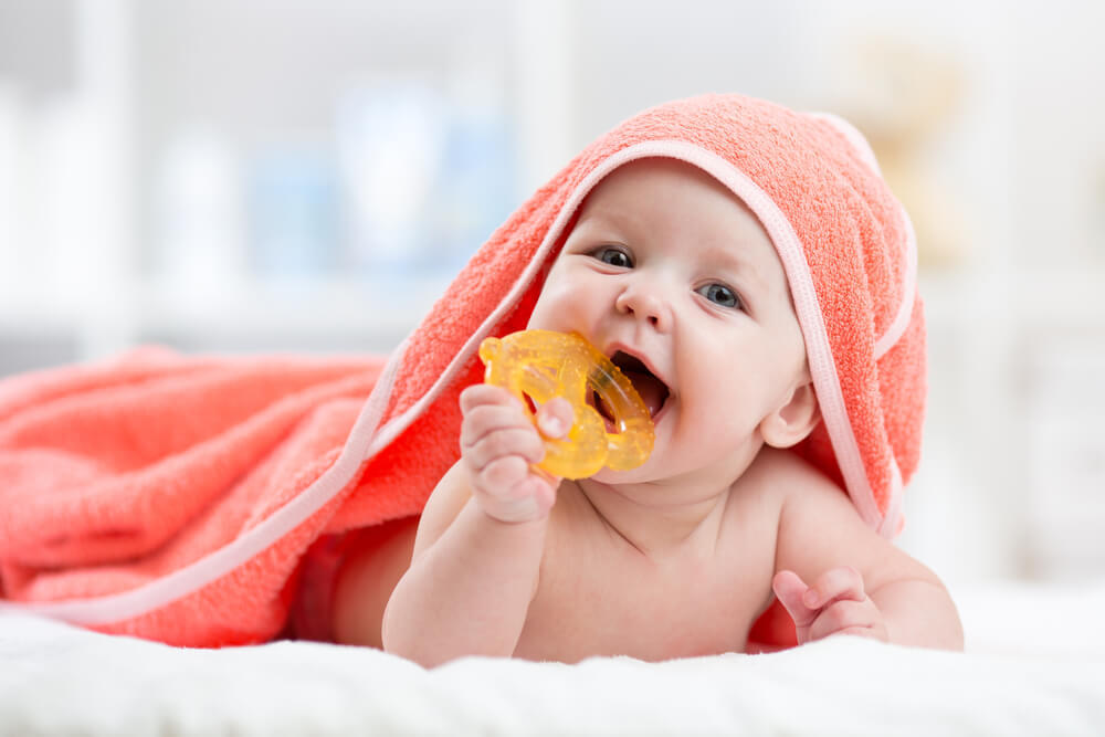 Cute baby with a teething toy.