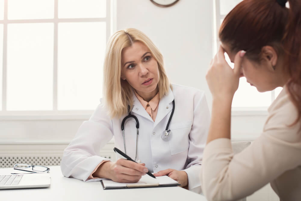 Serious Female Doctor Consulting and Diagnose Desperate Woman