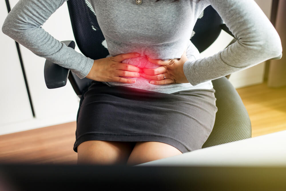 Woman Having Painful Stomach Ache During Working From Home