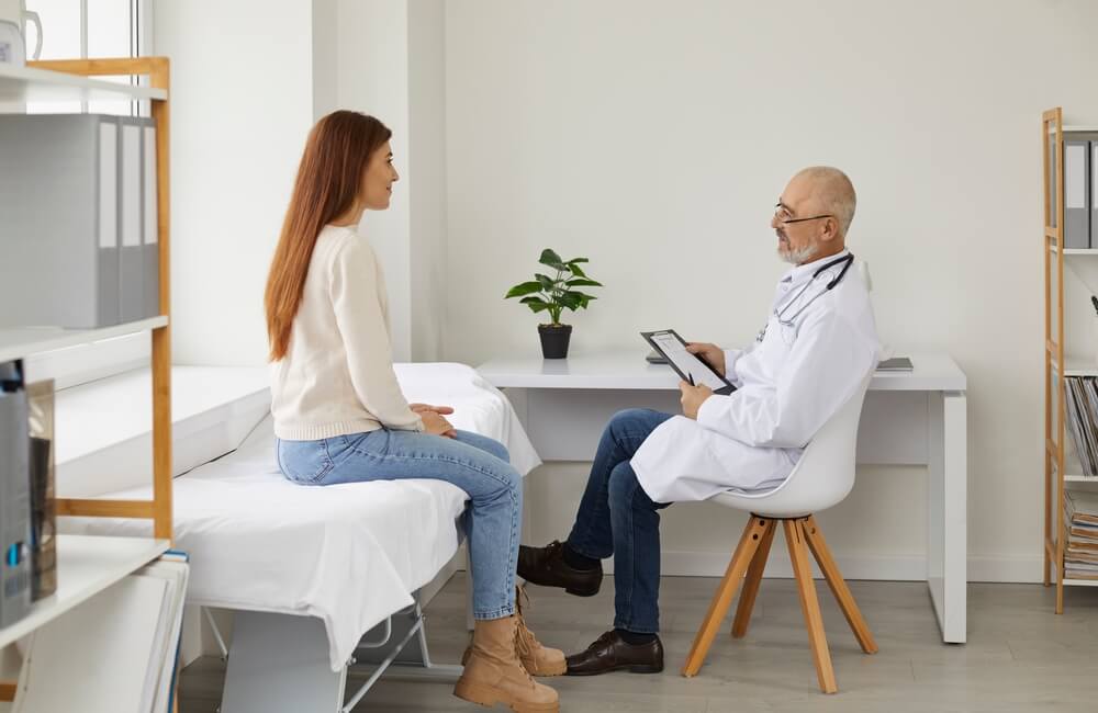 Doctor Consulting Female Patient in Hospital.