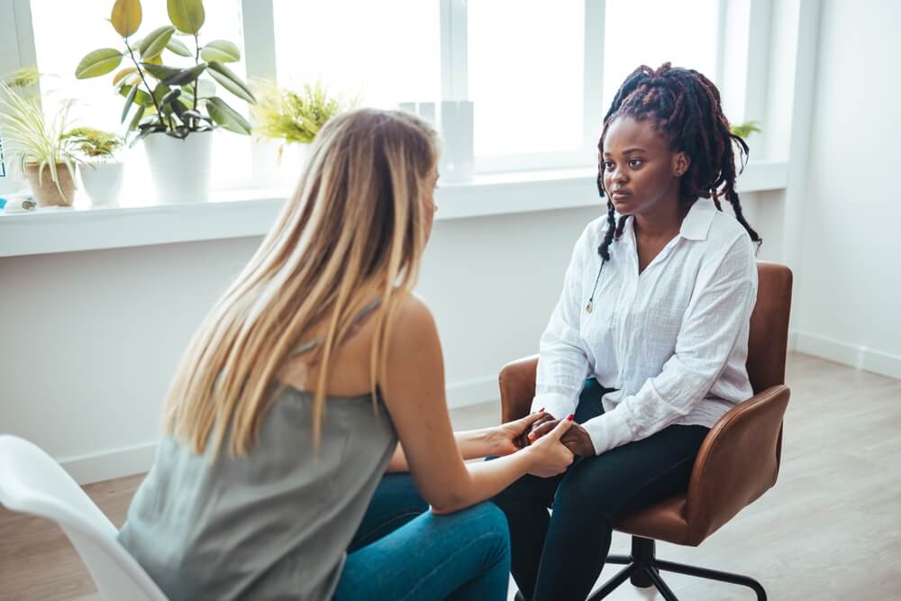 Stressed Black Female Patient Consulting Psychologist at Medical Office Selective Focus