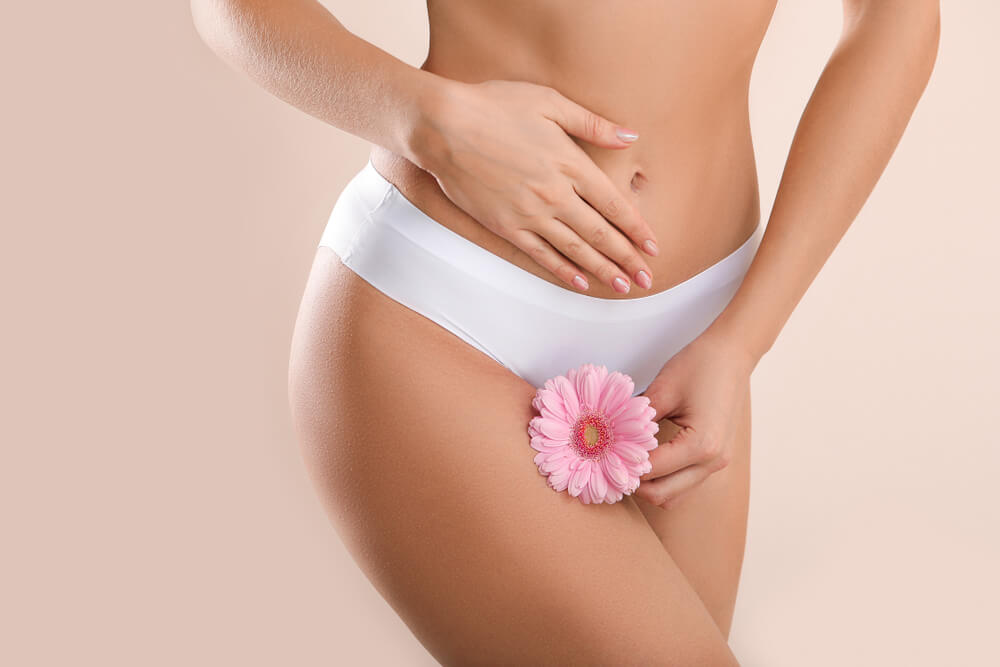 Young Woman With Flower on Light Background Gynecology Concept