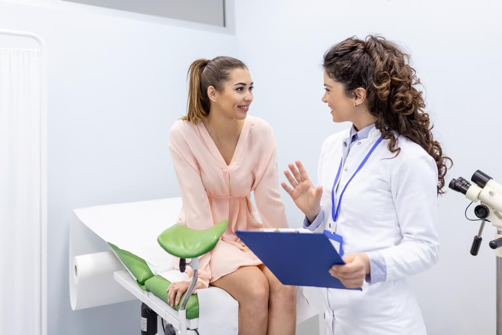 Female patient in a gynecological chair during a gynecological check-up.