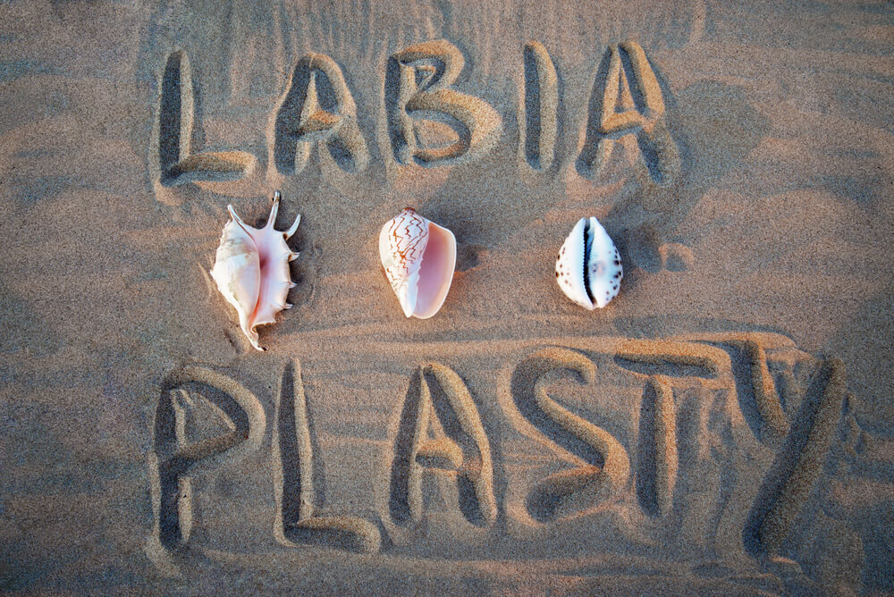 Labiaplasty inscription in the sand.
