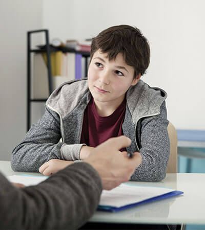 dark haired boy in grey hoodie having consultation with a doctor-2