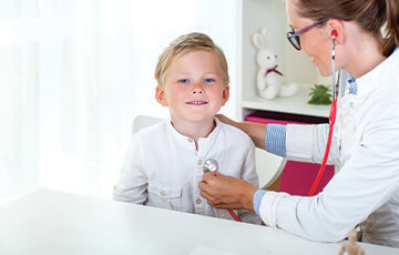 blue haired boy getting a stethoscope exam-1