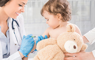 toddler with teddy bear getting vaccinated-1