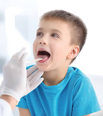 young boy in blue shirt basic throat examination-2