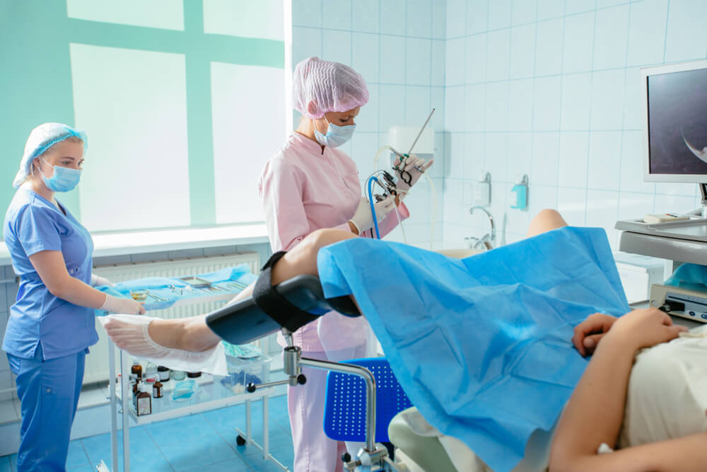 Woman Gynecologist and Female Assistant With Hysteroscopy Equipment Carry Out Operation in Gynecology Medical Center