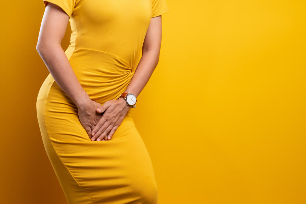 Closeup Sick Woman With Hands Holding Pressing Her Crotch Isolated on Background