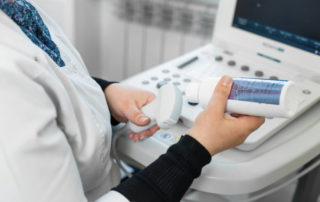 Doctor Prepare an Ultrasound Machine for the Diagnosis of a Patient.