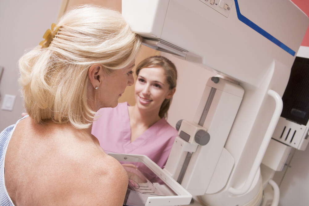 Nurse Assisting Patient Undergoing Mammogram