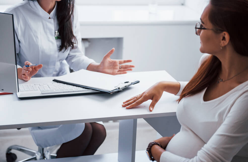 Pregnant Woman Have Consultation With Obstetrician Indoors.