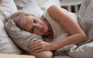 Close up view sleepless middle-aged woman lying in bed suffers from insomnia