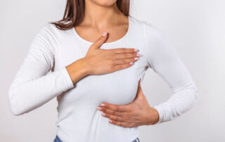 Woman Wearing a White Tank Top Checking Her Breast Breast Self-Exam Bse