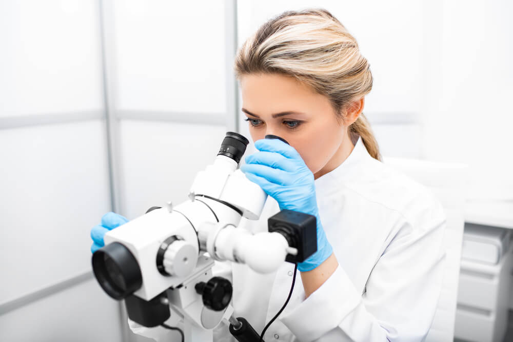 Portrait Positive Gynecologist Woman Sitting Near a Colposcope in Her Gynecological Office. Gynecologist Profession