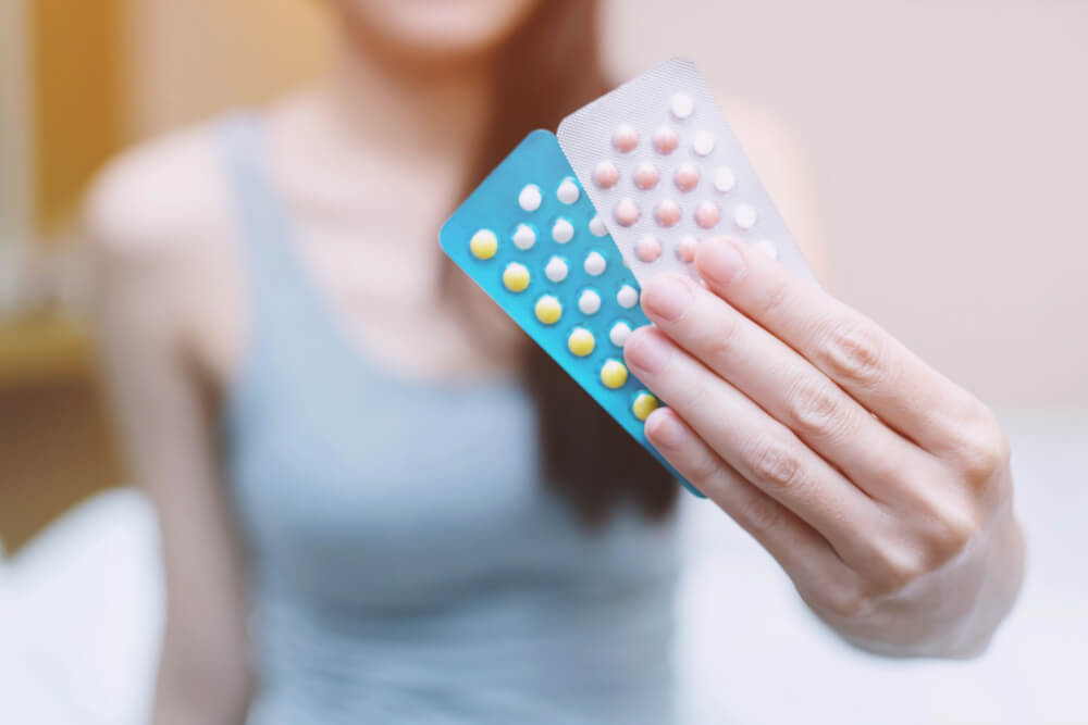 Woman Hands Opening Birth Control Pills In Hand Eating Contraceptive Pill