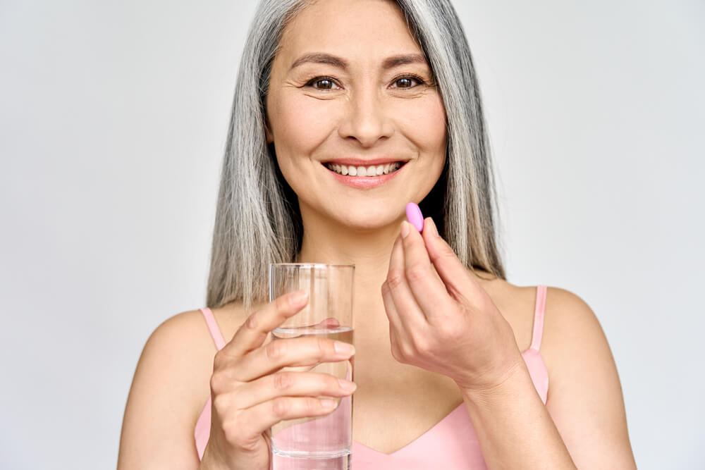 Smiling adult woman taking care of health in menopause.