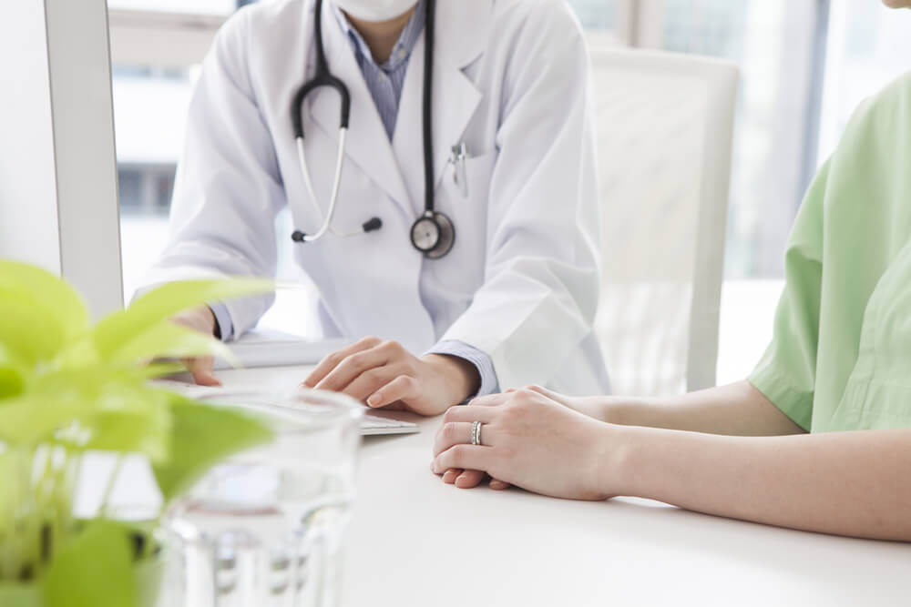 Doctor Talking To Her Woman Patient at Office