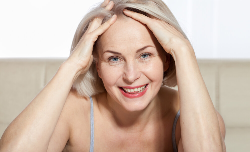 Cheerful Senior Woman Smiling While Looking Away at Spa.