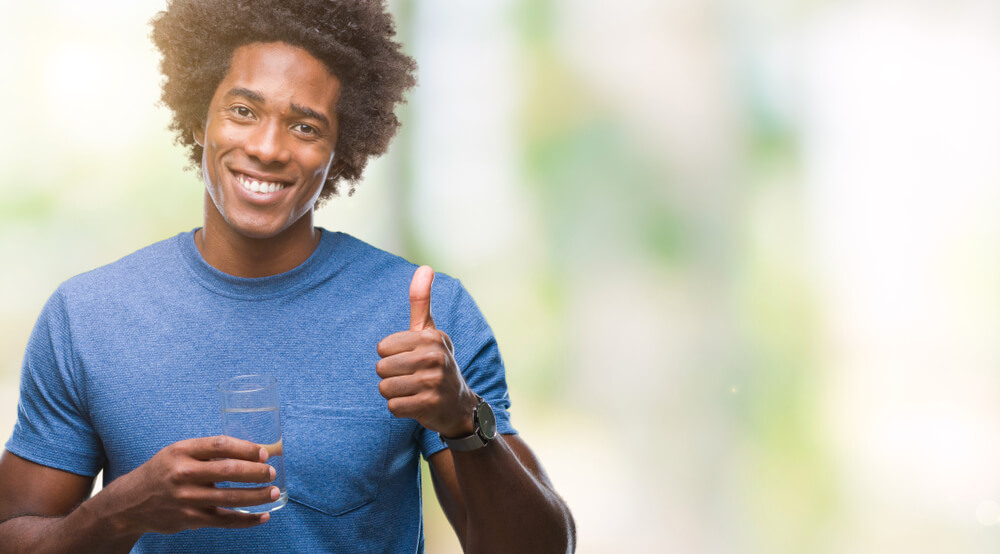 Afro American Man Drinking Glass of Water Over Isolated Background Happy With Big Smile Doing Ok Sign