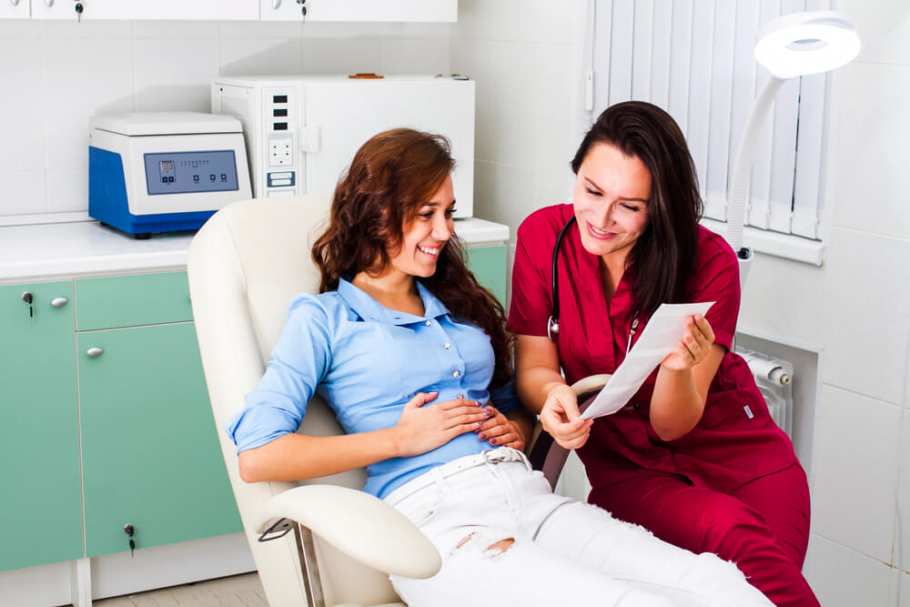 Happy Pregnant Woman in the Gynecologist’s Office.