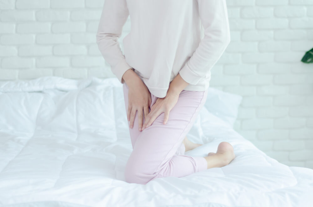 Close up Woman Wearing Pink Pants the Itching on Vaginal. The Woman’s Hand Placed Between Her Legs. She Has Itching at the Vaginal